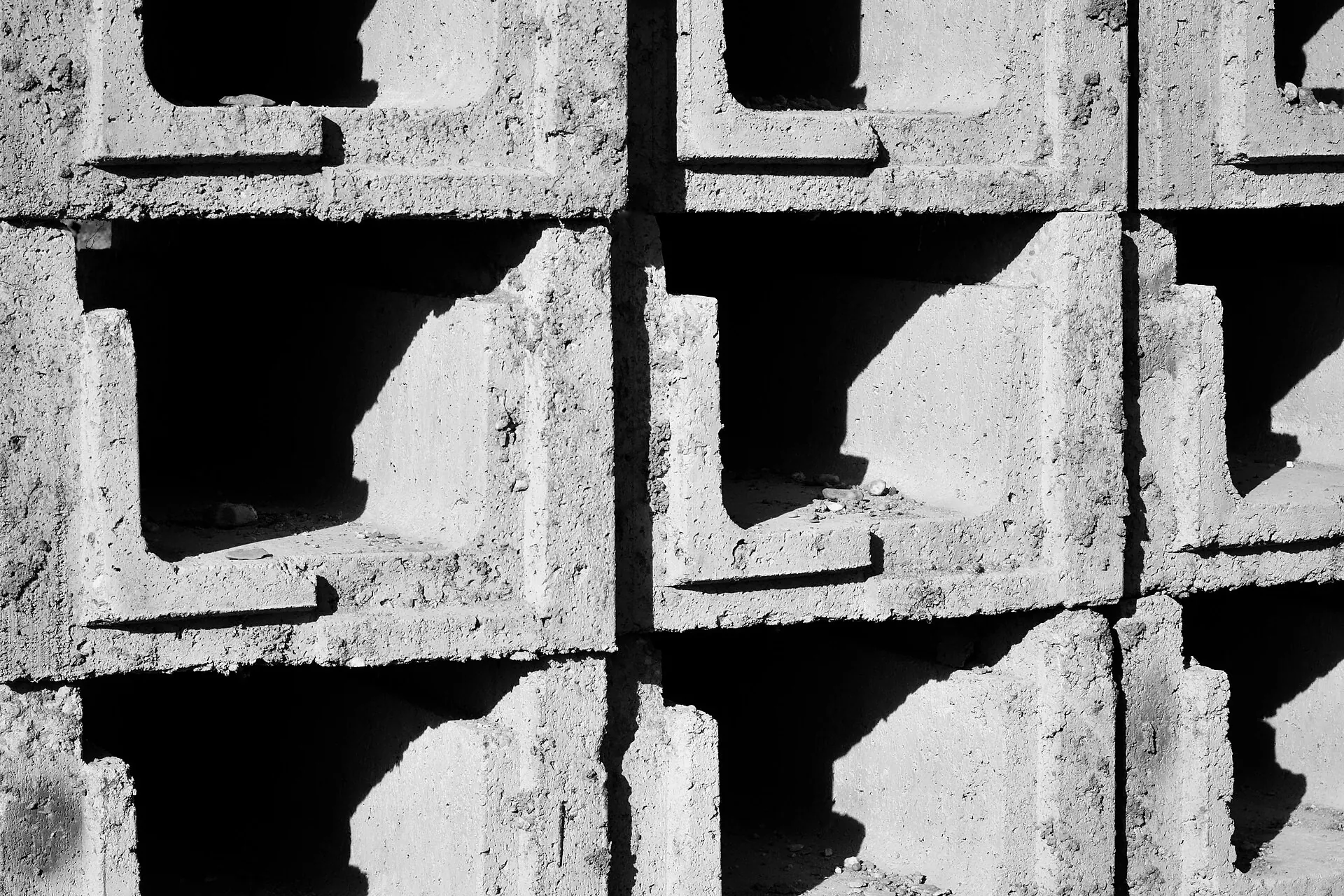 Stacked hollow concrete blocks in sunlight