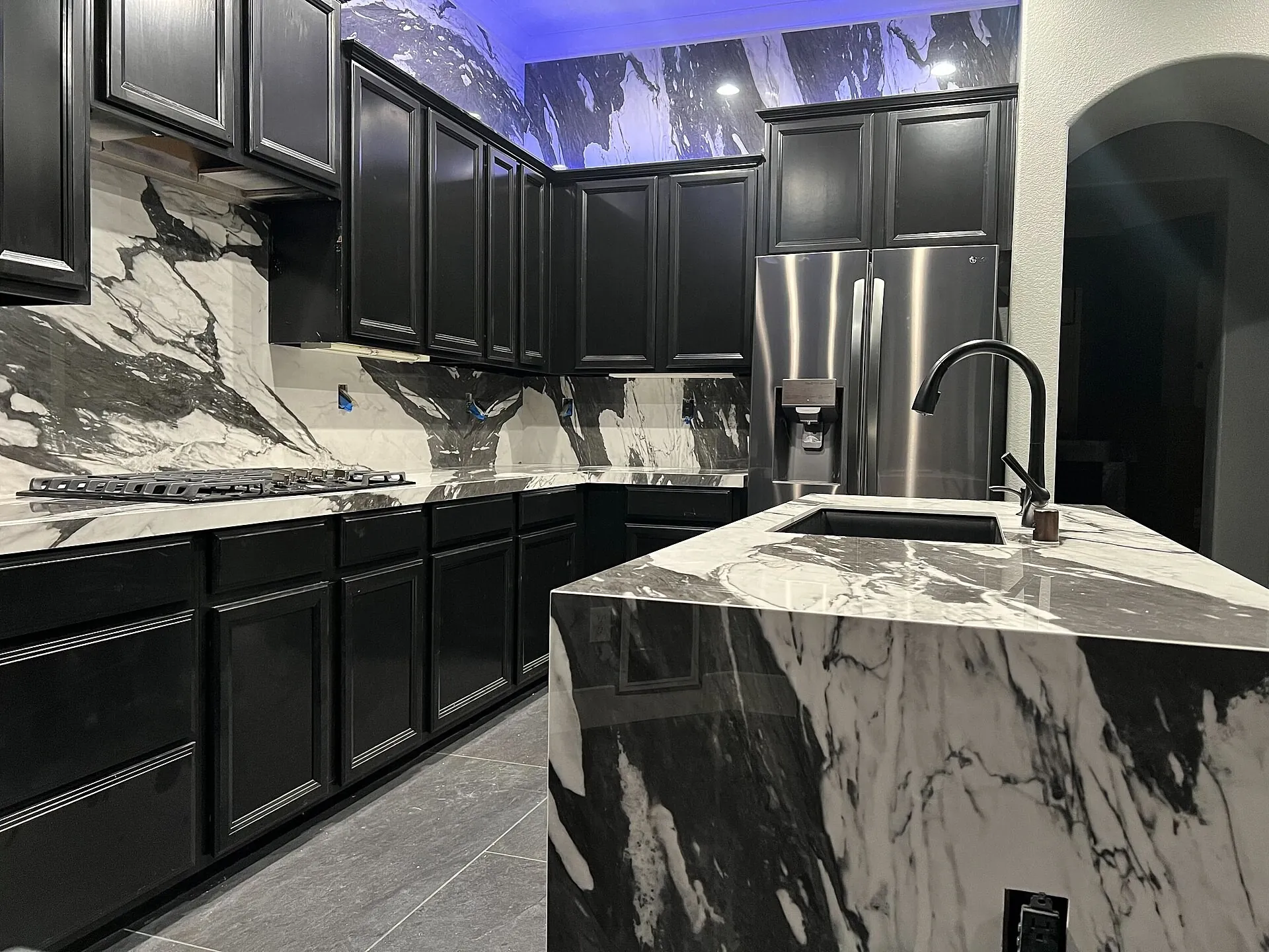 Kitchen island with a marble-finish stone countertop