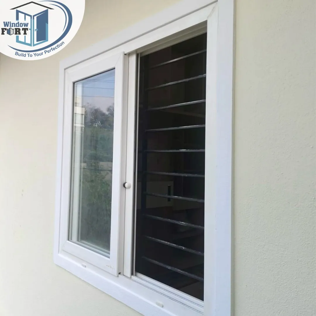 White casement window with louvred shutter, fitted in a wall