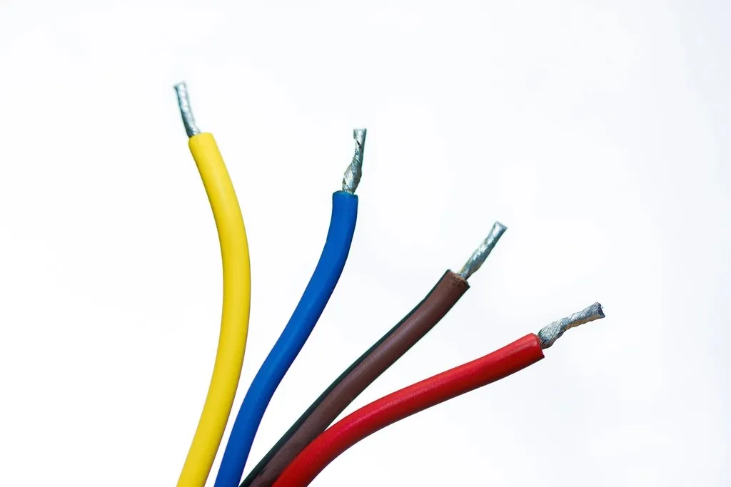 Insulated electrical wires in yellow, blue, brown and red