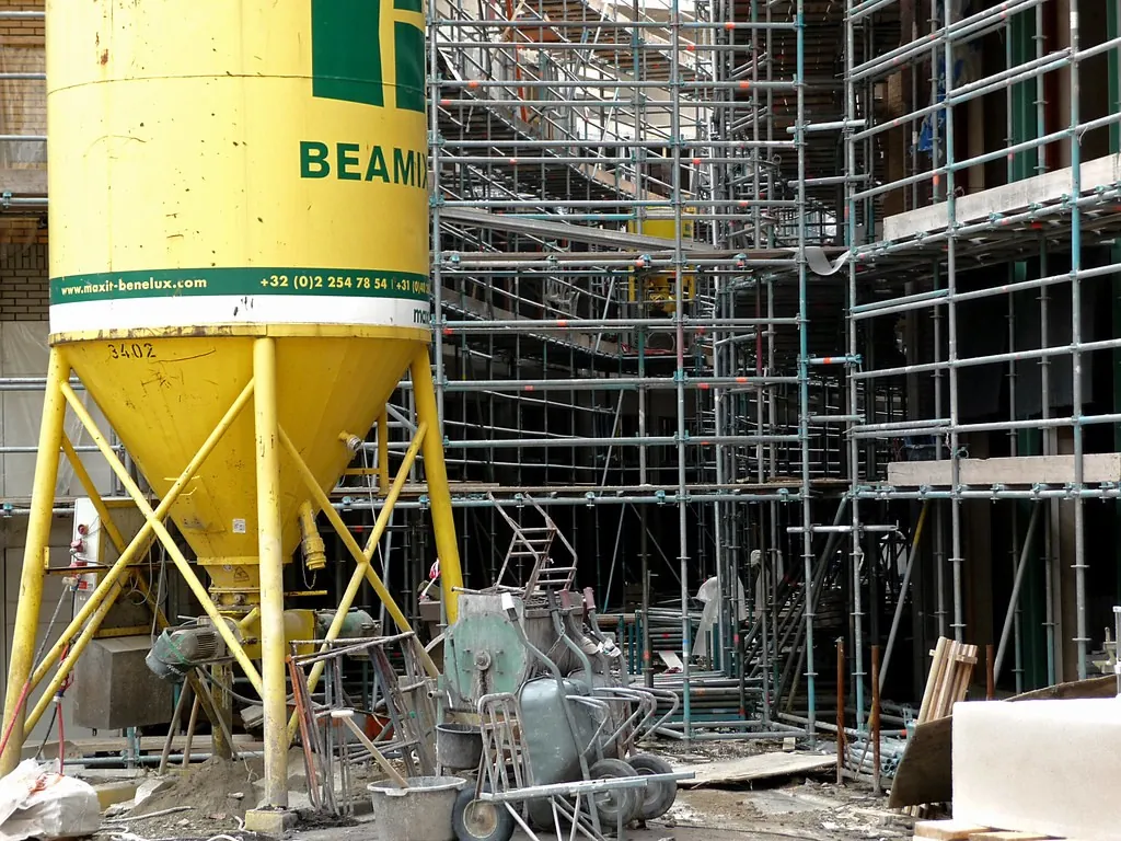 Building site with a material silo and scaffolding